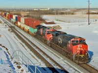 Viewed from the new Range Road 231 over bridge CN 2830 leads an east bound intermodal over the now disused Range Road 231 grade crossing.