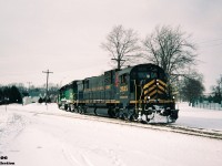 Cape Breton & Central Nova Scotia Railway (CBNS) C630M 2035 and leased GATX GP40G 3080 bring a heavy Goderich-Exeter Railway (GEXR) train into Stratford, Ontario on February 6, 1994. The winter of 1993-1994 was a brutal one for GEXR’s fleet of second-hand GP9’s and by early February, most were either out of service or severely ailing. Cold winter weather and daily battles with squalls coming-off Lake Huron had proven too much for the veteran GP9’s, so RailTex turned to sister railway CBNS for help. The east coast shortline sent big MLW 2035 which operated between Stratford and Goderich for a couple weeks to help alleviate GEXR through their motive power crunch. In the end, 2035 would fare no better and would eventually be sent back east dead and in need of required repairs.