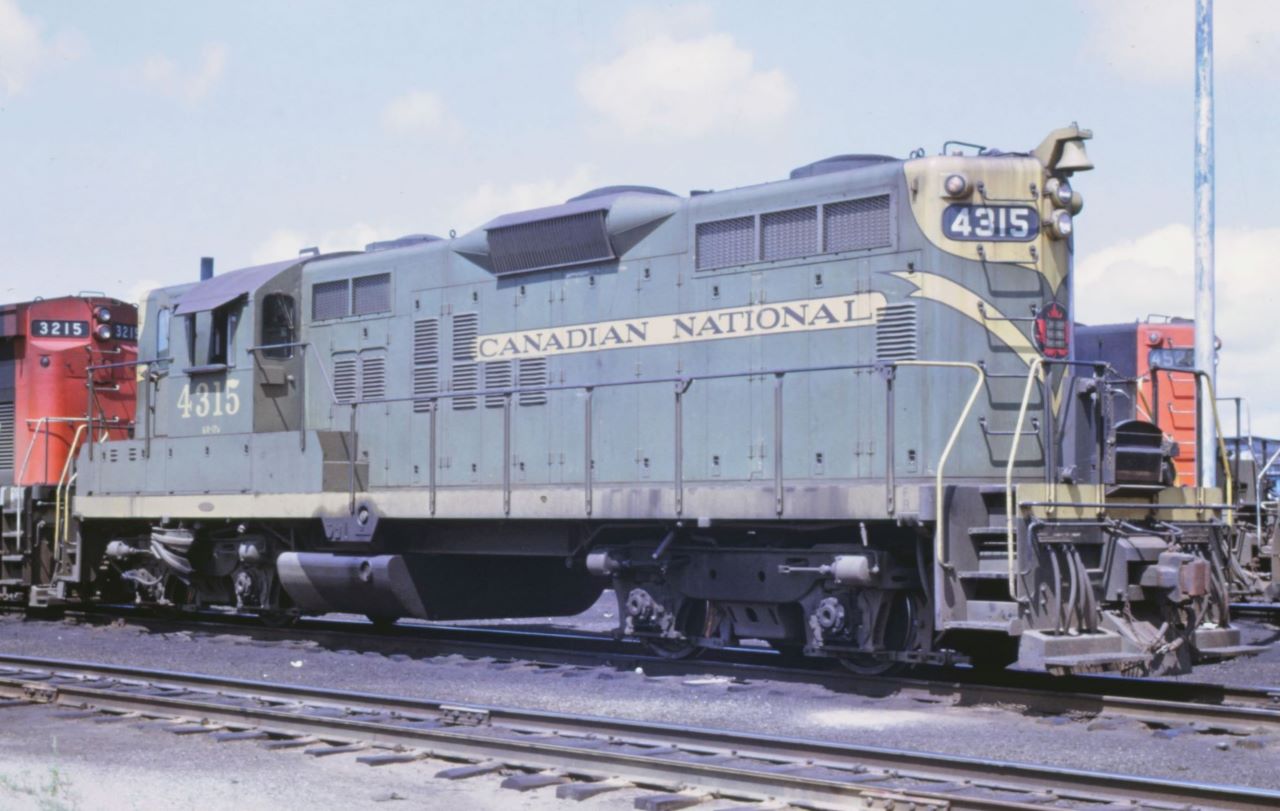 A pair of "15's" rest on the ready track at Capreol, Ontario on August 6, 1969.  The 4315, built by GMDD in 1959, was the star still in its as delivered paint.