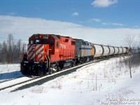 VIA to Owen Sound? Close: in a rare occurrence, one of CP's <a href=http://www.railpictures.ca/?attachment_id=48156><b>leased VIA F40PH-2 units</b></a> found its way onto The Moonlight, and made a trip up the Owen Sound Sub north to Owen Sound! CP GP38-2 3041 leads VIA F40PH-2D 6449, six Indusmin cylindrical covered hoppers, and van 434731 as they enter the Owen Sound city limits at the north end of town just after 11am (around the area of East Bayshore Rd & 3rd Ave).
<br><br>
CP leased a handful of VIA F40 units in 1994-1995 to help with their ongoing power shortage, and they typically operated around the southern Ontario area and on Windsor-Toronto-Montreal freights, usually with other CP units and leasers due to their higher-speed passenger gearing not being optimal for freight service.
<br><br>
Icing on the cake at this time was CP's operations over the Owen Sound Sub between Orangeville to Owen Sound were on borrowed time, and only had a few more months of operation left before the line was abandoned (the final train departed Owen Sound in October 1995).
<br><br>
<i>Peter Jobe photo, Dan Dell'Unto collection slide.</i>