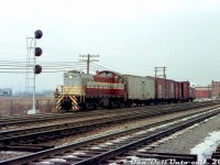 Canadian Pacific MLW S3 6550, sporting a pair of white extra flags, comes off the CP Canpa Sub with a short local job entering CN's Oakville Sub at the Canpa interlocking (note the brick Canpa tower in the background, governing CN and CP traffic). CP had a longstanding agreement with CN for running rights over the Oakville Sub between downtown Toronto (Bathurst St./Cabin D) and Hamilton Junction, and CP locals often came from West Toronto/Lambton Yard area down the Canpa to work some of the joint-section industries along the Oakville Sub, as well as interchange cars with CN at their Mimico Yard (the trailing steel CN ice reefer and 40' boxcar might be interchange traffic for CN).
<br><br>
It took a bit of love to coax some colour and contrast back into this old faded Eddie Blacks colour slide. No date or date stamp was visible, but it was likely taken sometime in the late 1950's to early 1960's.
<br><br>
<i>Original photographer unknown, Dan Dell'Unto collection slide.</i>