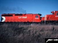 A CP westbound in the siding with SD40-2 6021 meets an eastbound on the mainline with SD40 5515 at the west end of Killean siding in Galt, Ontario. 