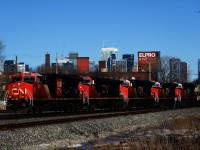 Empty potash train CN B731 has five GEs up front and a sixth on the tail end as it heads west.