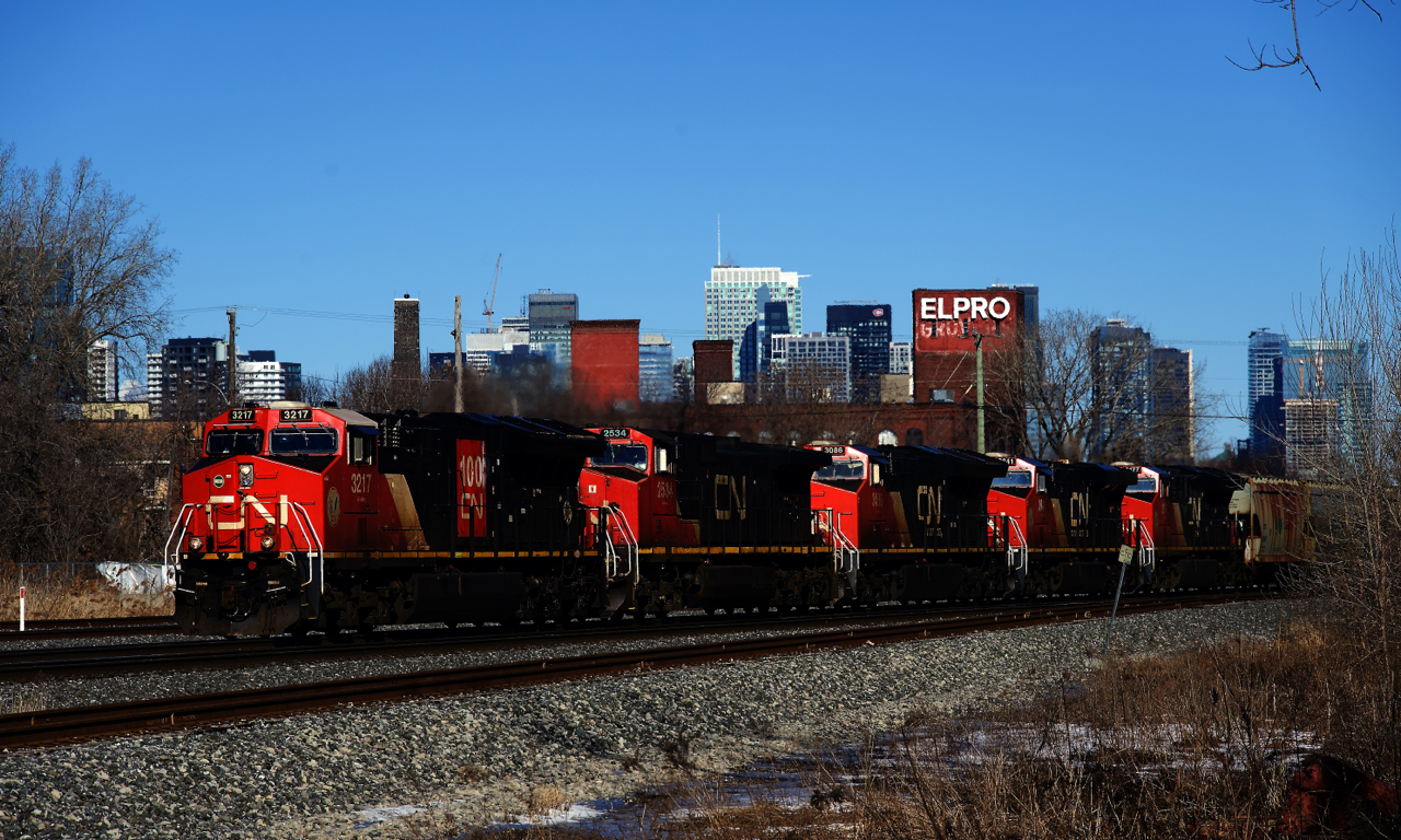 Empty potash train CN B731 has five GEs up front and a sixth on the tail end as it heads west.