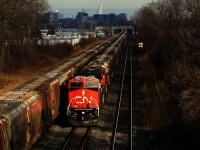 Potash trains meet as empty potash train CN B731 passes parked and loaded potash train CN B730 near Ballantyne. Recently rebuilt CN 3336 is leading.