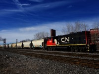 Uncommonly, St-Hyacinthe switcher CN 519 has made a run to Montreal and is heading back there with a long string of cars taken off the Freight Track.