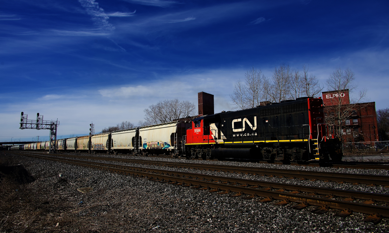 Uncommonly, St-Hyacinthe switcher CN 519 has made a run to Montreal and is heading back there with a long string of cars taken off the Freight Track.