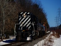 The chemin de fer Lanaudière is heading to Joliette (to interchange with the Québec-Gatineau Railway) with 3 tank cars and 2 hoppers on a sunny morning.