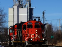 CN 587 with a pair of GP9s has just lifted a single hopper from the mill in the background. It will couple that car to the rest of the train and then head south to the next client, in Crabtree.