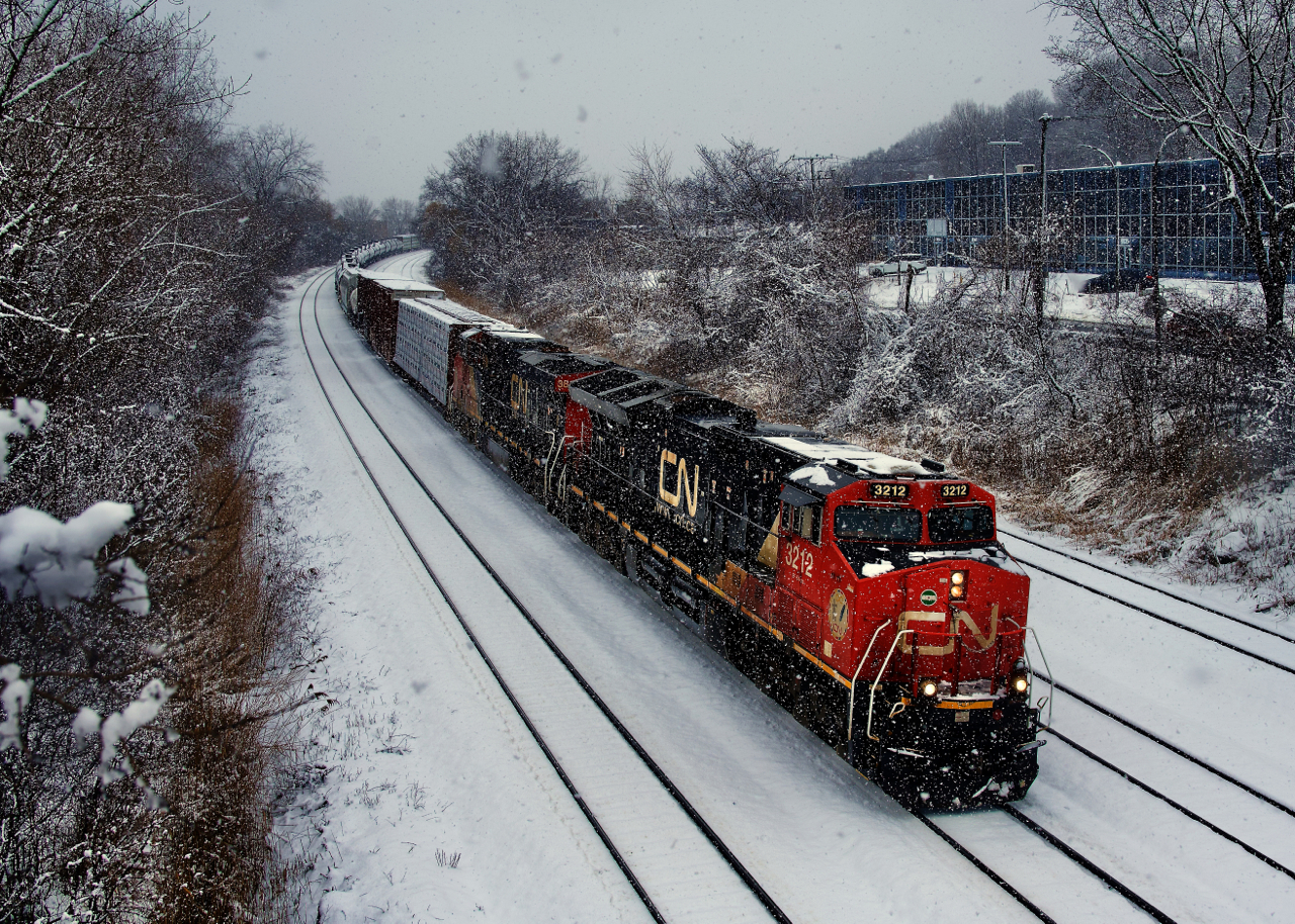 A short CN 324 rounds a curve during some heavy but short-lived snow.