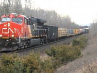CN train flies through mile 30 on a cloudy morning with CN 3182 a solo tier 4 in lead. 