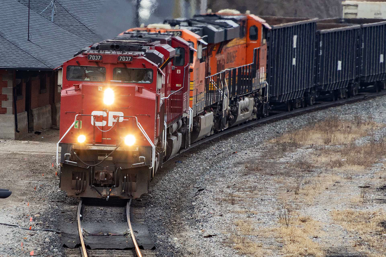 The "Twins", 7037 and 7030 have joyously been assigned to 238-239 for a few weeks; freedom from the sea of GEs and a real treat. Even more unique and colourful, on this day a pair of BNSF's GE's ar tagging along on the trip to Welland. Tomorrow, (the day 26th of feb that was), there would be 2 239's; the ACU's on the first, and the 2 BNSF's with a  raft of empty autoracks for Wolverton. An embarrassment of riches passing Galt Station.