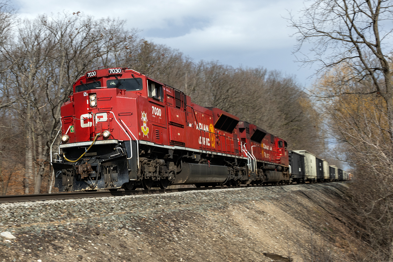 CP's power control, with whom I am usually highly frustrated, has granted Southern Ontario a gift. For the last couple of weeks, 2 of CP's 59 SD70ACU's have been assigned to trains 238-239 which once travelled London- Buffalo, but now flip in Welland. This shortcut has had 239 coming west in daylight as opposed to after dark; the nightmares of getting in and out of the US removed. 

So taking advantage of the chance to catch one of the 2 CP Strathcona units in motion, aided by 7037, 7030 attacks Orr's Lake Hill with a short fast train.