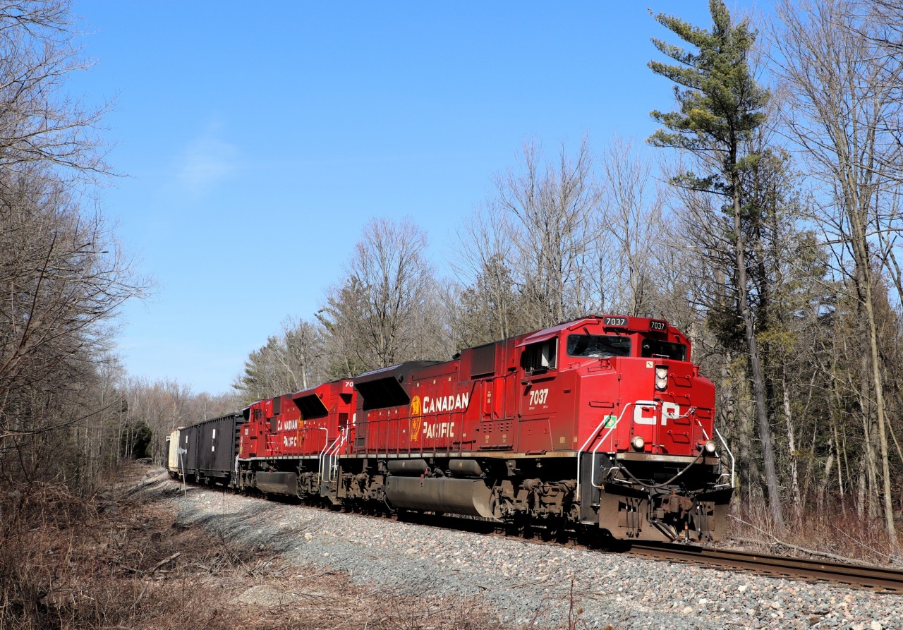 This pair of SD70ACu's has been roaming the area for quite a while as CPKC 238 South and CP 239 North. Little did I know that this southbound trek as CPKC 238 led by CP 7037 with CP 7030 would be its final trip down the Hamilton sub during this run. The pair returned north later in the day on CPKC 237 and then went west on CPKC 135 during the early hours the next morning. Here, they round the bend through the woods on the approach to the 3rd Line on a bright warm spring afternoon. The lack of leaves let the sun in nicely.