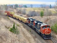 One of my favourite angles on the Halton subdivision, that unfortunately can never be done on a sunny day no matter the time. I’ve always like how this spot retains the old N&NW branchline feel minus the welded rail. I spent a lot of my Railfan youth on the hillside beyond the double stacks with a good group of friends, long before the golf course and steel bridge was here. Back then a farmers crossing was located in the cut allowing the farmer access to his fields split by the rail line. Even with the dormant landscape it is still a nice scene with the big clubhouse and Niagara Escarpment in the distance. This day my youngest son joined me as CN 148 storms upgrade with a pair of SD70M-2’s in the lead. It won’t be long before the golf course is open again and railfans banished from the bridge.