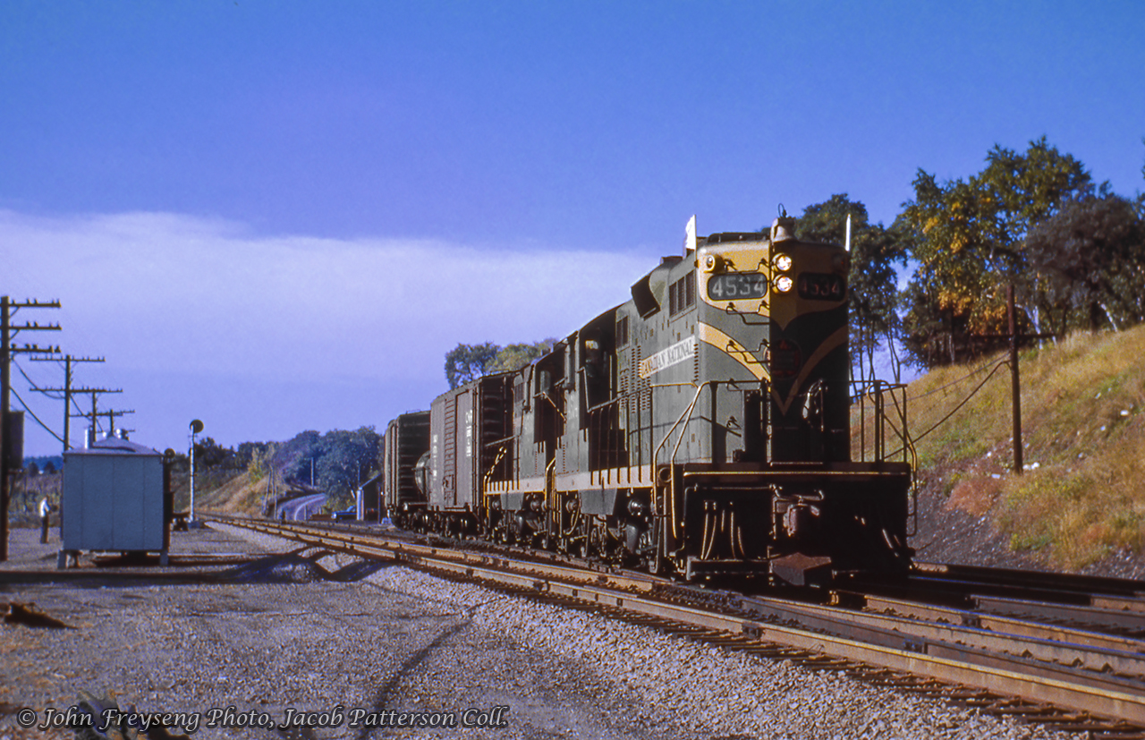Bound for Mimico, Extra CN 4534 east swings onto the Oakville Sub at Bayview Junction, crossing over to the south track.John Freyseng Photo, Jacob Patterson Collection Slide.