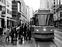 TTC CLRV 4130 pauses on a wet afternoon to load passengers amid the downtown towers of one of Toronto's major crossroads, Yonge and Dundas, on an eastbound 505 Dundas run. It was only a few days before Christmas, but there was a distinct lack of snow that whole winter ("first snow" noted on December 27th, and it never stuck around for long).
<br><br>
Still a handful number of years away from replacement by new Bombardier LFLRV streetcars, 4130 soldiered on until its retirement in November 2017.