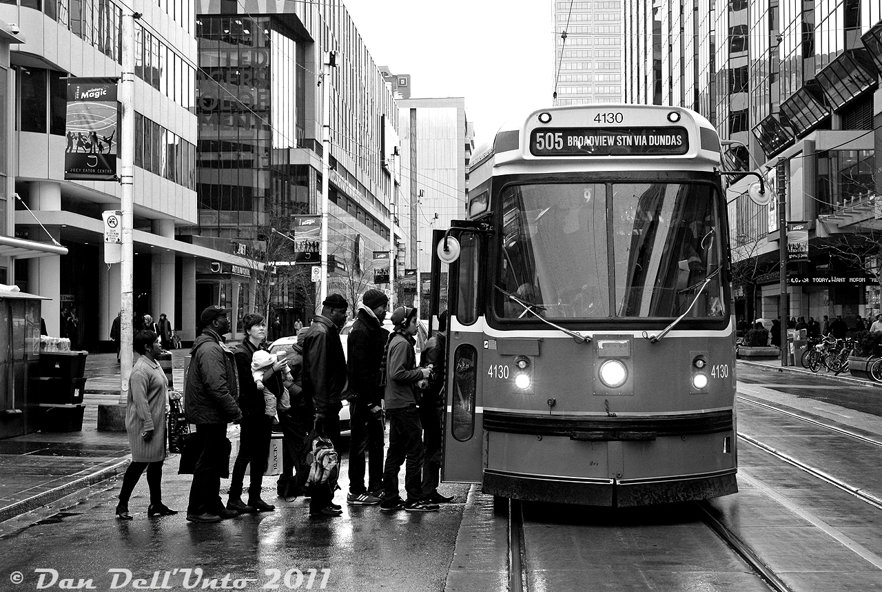 TTC CLRV 4130 pauses on a wet afternoon to load passengers amid the downtown towers of one of Toronto's major crossroads, Yonge and Dundas, on an eastbound 505 Dundas run. It was only a few days before Christmas, but there was a distinct lack of snow that whole winter ("first snow" noted on December 27th, and it never stuck around for long).

Still a handful number of years away from replacement by new Bombardier LFLRV streetcars, 4130 soldiered on until its retirement in November 2017.
