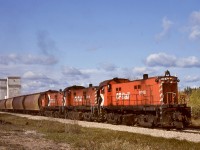 From Prince Albert, CP accessed their White Fox subdivision via three sections of CN joint trackage for 18 miles, then on CP rails east from Sharpe to Nipawin.  To handle grain loads, a trip was run out to pick them up for delivery to Nipawin and returned with empties, and on Wednesday 1981-09-23 it was powered by a typical trio of lightweight (for CN branchline restrictions) RS-23s, CP 8018 + 8016 + 8014, shown here with five loads and a caboose departing Smeaton eastward at 1121 CST.

<p>Today, rails come west from Nipawin only to Choiceland, 13 miles away from here, now operated by Torch River Rail.