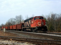 A CN Eastbound Ballast train with CN GP40-2(w) 9567 through Woodstock, ON as they approach the diamond of the OSR St. Thomas Sub that crosses the CN Dundas Sub back on April 6/2005.