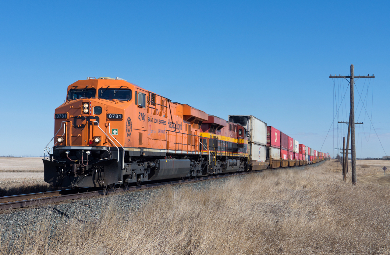 CP 8781 and KCSM 4748 hustle train 101 westward at Grande Coulee SK on a pleasant spring day.
