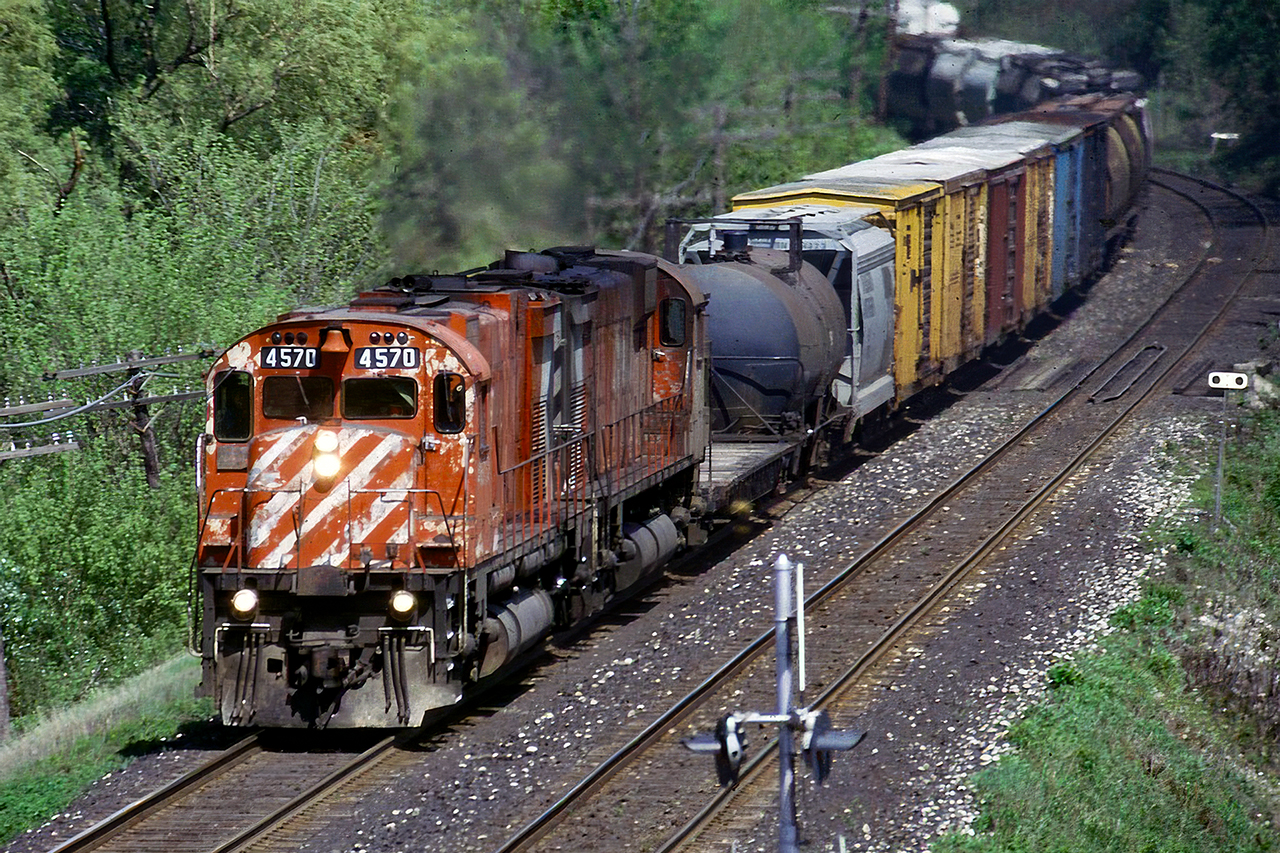 I don't have a whole lot of pictures of the big M's running out their last miles. But while sitting in Milton next to the CN bridge over CP I was lucky enough to have this sight for sore eyes come around the corner. I'm, am still of the opinion that 1990-1997 was the greatest time for railroading in North America. The power was almost always all at the front, trains were plentiful, DPU's didn't exist, someone around the tracks wasn't viewed as a national security threat, release forms got you free tours of the yard, but mostly, that anything might be leading coming around the corner.