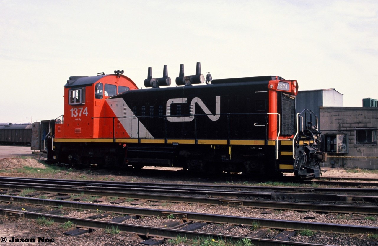During a spring morning, CN SW1200RS 1374 is viewed waiting for its next assignment at CN’s Stuart Street yard’s small shop in Hamilton, Ontario. The unit was repainted in the CNNA scheme the year prior. It was eventually retired on April 6, 1999, and would later become CN CS-03.