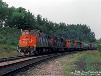 An eastbound extra freight comes down the hill off the Dundas Sub at Bayview Junction, lead by CN M420W 2556, C630M 2024, and GP40-2L(W) units 9549 and 9559.<br><br><i>Bill McArthur photo, Dan Dell'Unto collection slide.</i>