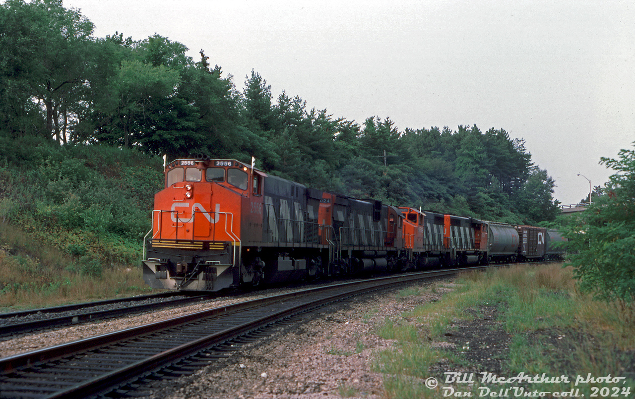 An eastbound freight comes down the hill off the Dundas Sub at Bayview Junction, lead by CN M420W 2556, C630M 2024, and GP40-2L(W) units 9549 and 9559.

Bill McArthur photo, Dan Dell'Unto collection slide.
