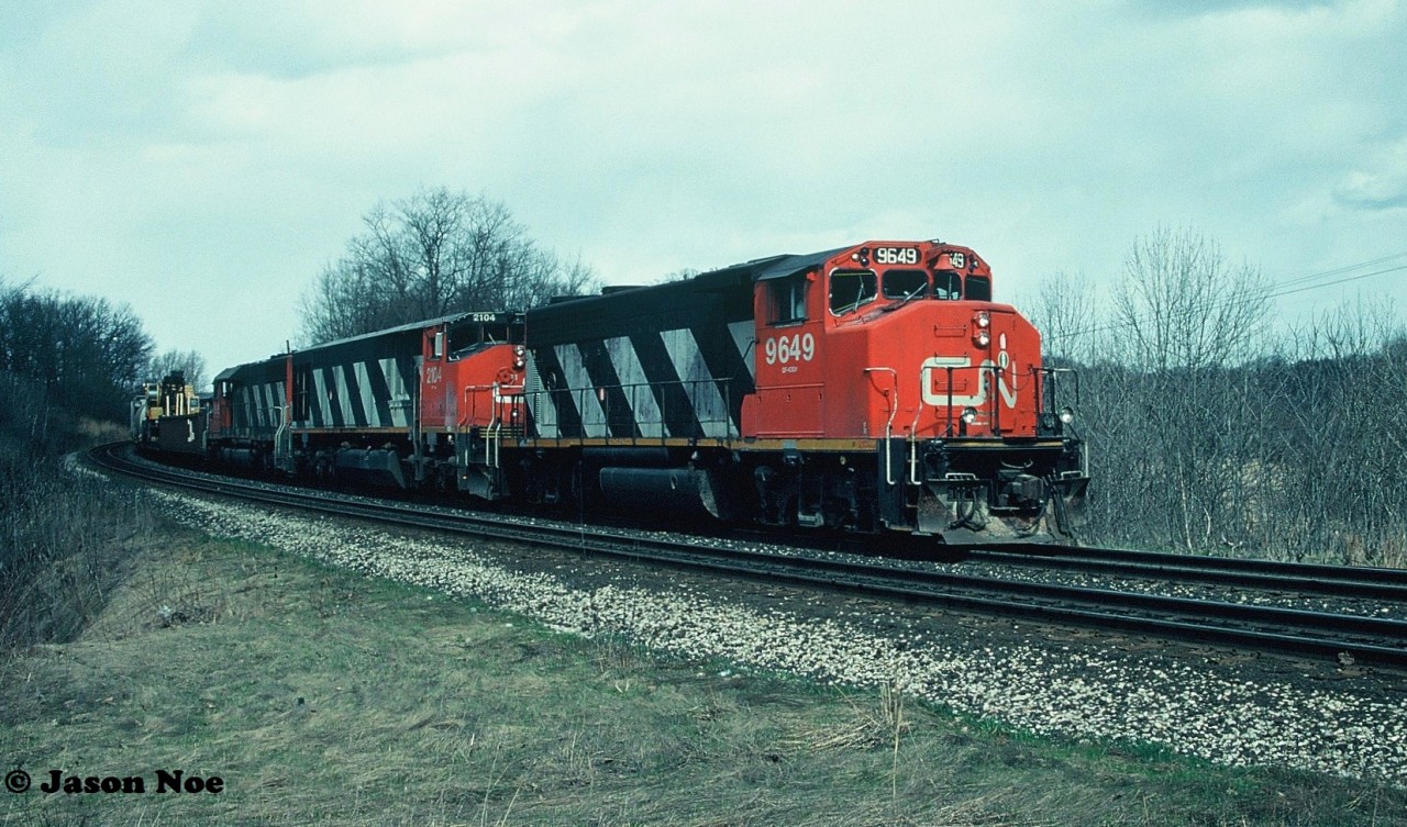 CN 411 is pictured during a sunny break approaching Bayview Jct. on the Oakville Subdivision in Burlington with 9649, 2108 and a 5100-series SD40.