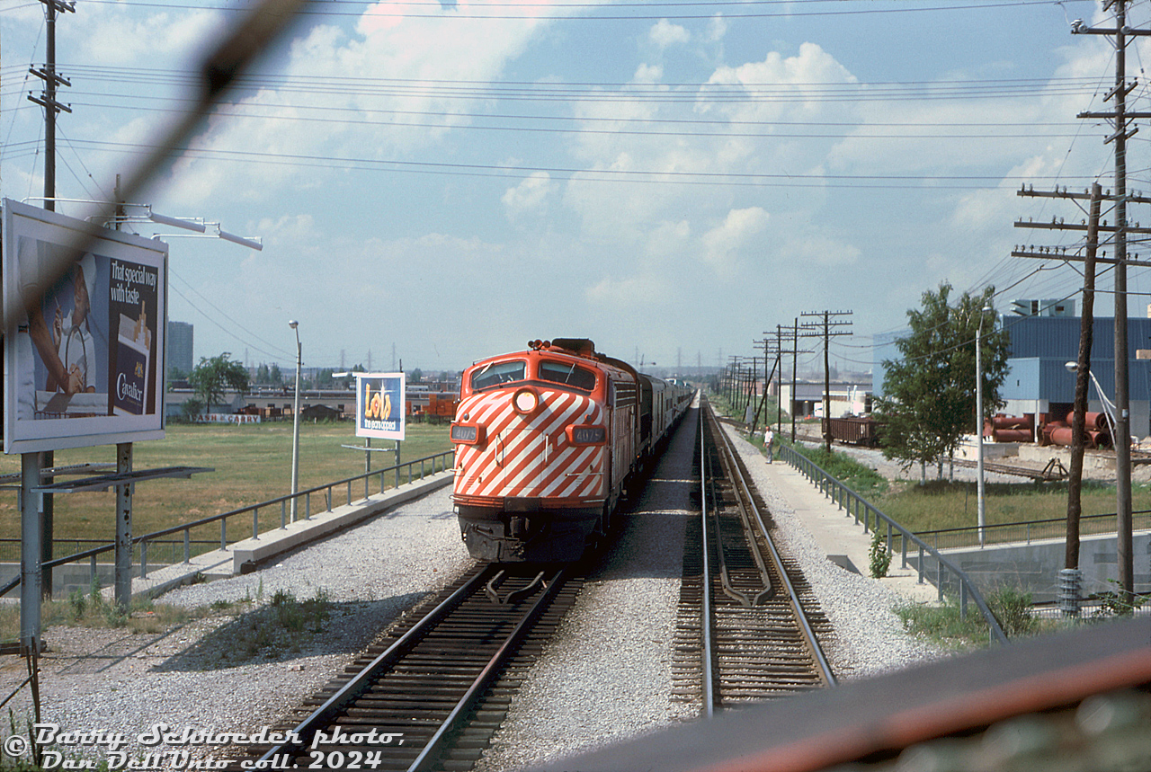 Riding north in the lead F-unit on CP Rail train #11, "The Canadian" (Toronto-Sudbury leg), the train has stopped at Sheppard (Mile 6.5 CP MacTier Sub) for a meet with the southbound Canadian (#12) inbound to Toronto. CP FP7 4075 and an RS10 lead #12 south, about to cross over Sheppard Avenue underpass. A crewmember hangs out of one of the head-end cars, as another from #11 waits on the overpass to give an ok roll-by inspection.

Since the line north of Emery into Woodbridge and beyond is single track, it's likely the northbound #11 was waiting here for the (late?) southbound #12 to clear. This photo was taken during the final months of The Canadian operating on CP out of Toronto, as after the VIA takeover in September, The Canadian would be rerouted over the CN Bala and Newmarket Subs at end of October 1978.

On the right, a CN gondola is spotted on the siding for Tepsons. Other industries in the Sheppard area at the time with Southam Murray (Printing), Woolworth's warehouse, Dow Chemical, and the North York Hydro spur

Barry Schroeder photo, Dan Dell'Unto collection slide.