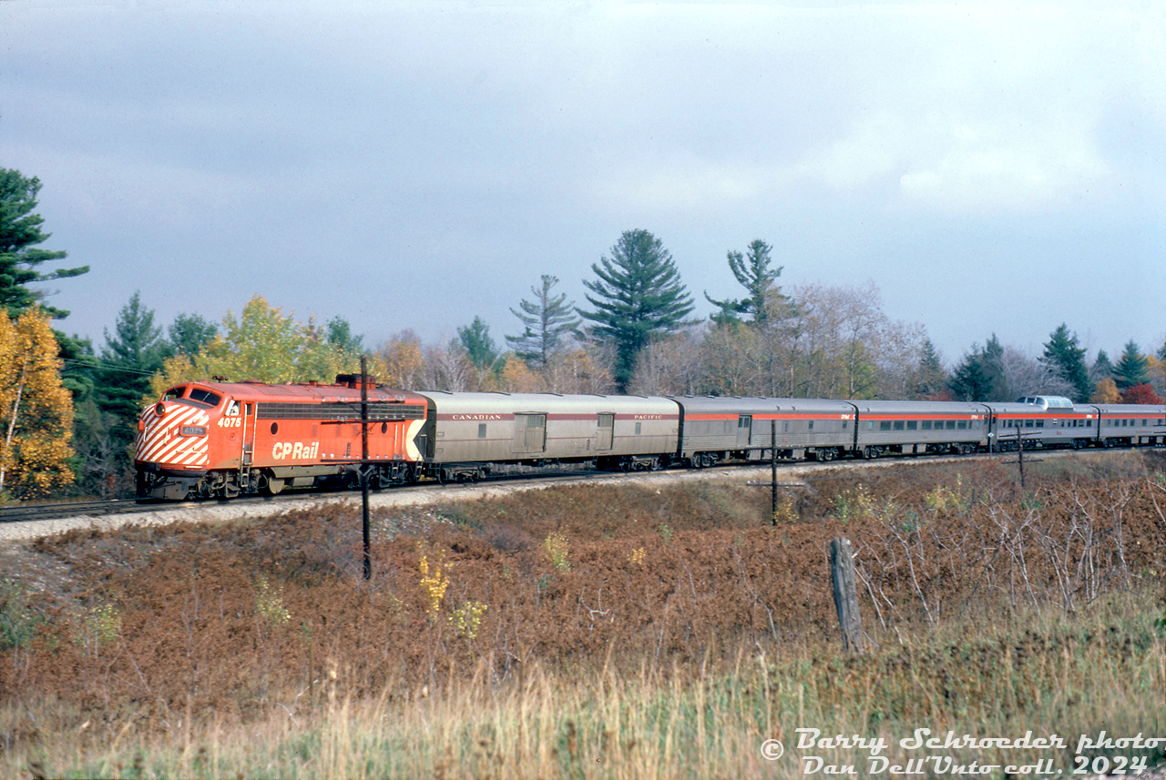CP Rail FP7 4075 leads a short consist of #11 "The Canadian" (Toronto-Sudbury) northbound on the MacTier Sub near Medonte. A single F-unit was usually enough to handle the short #11/12 consists in the later years of CP operation, as the consists weren't very long off-peak (usually only having a Skyline dome, and no Park car). An old steel rounded-side baggage painted silver to match the previous livery trails the power, followed by a "bare bones" consist of a baggage-dorm, coach, Skyline dome, dining car, and possibly a sleeper or two (cut off).

The exact location of the train was not noted other then Medonte. It was shot from a road by a crossing (out of frame to the left). With the curve in the line it sort of seems like the crossing at Upper Big Chute Road south of Severn Falls, but it's hard to say for sure.

Barry Schroeder photo, Dan Dell'Unto collection slide.