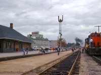 With its <a href=https://www.railpictures.ca/?attachment_id=45078>photo stop alongside CNR 6167 complete,</a> CNR 6060 starts to pull down to Guelph's station for another brief stop.  Todays trip was chartered by the Buffalo Chapter of the National Railway Historical Society, running from Niagara Falls to Guelph via Lynden and Harrisburg Junction.  GP9 4524 at right is the power for the Guelph yard job, tied down with its van in track XW41.
<br><br>6060's travels were well documented on this trip:
<br><a href=https://www.railpictures.ca/?attachment_id=44599>Northbound through Harrisburg,</a> Bryce Lee
<br><a href=https://www.railpictures.ca/?attachment_id=42990>Approaching Guelph,</a> Bruce Lowe
<br><a href=https://www.railpictures.ca/?attachment_id=14342>CN Guelph Junction,</a> Bill Thomson
<br><br><i>Donald Coulman Photo, Jacob Patterson Collection Slide.</i>