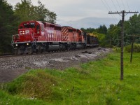 Freshly repainted CP 6012 and sister 5871 lug a heavy welded rail train up the Palgrave hill on a gloomy summer afternoon. CP's recent SD40-2 overhaul program has brought many units, including 6012, out of storage for repairs and a fresh coat of paint courtesy of Progress Rail. 