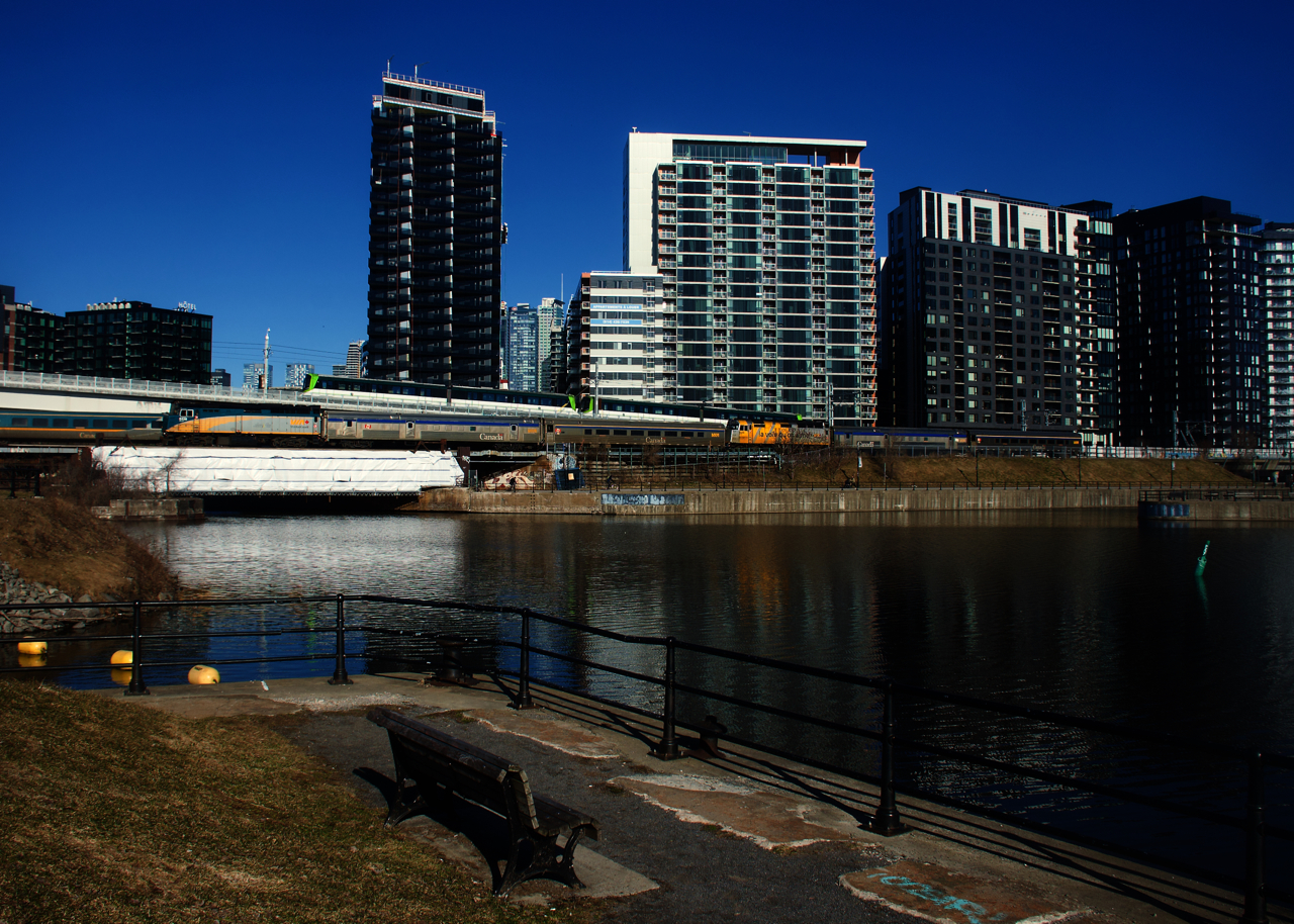 A late VIA 603/601 is backing up towards Central Station as an REM train passes overhead and VIA 63 passes it on the South Track.