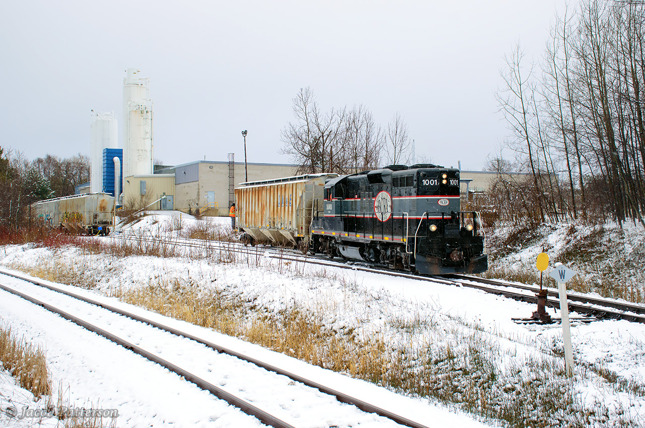 After a very dry winter in Ontario, an early spring snowfall provided a nice change for photography.  In the south end of Barrie, the lone GP9 of the Barrie Collingwood Railway is seen lifting a car from TAG Environmental, which will join another car from Comet Chemical destined for the CPKC at Utopia.  The change in the weather had the train slowly following a foreman throughout the day, who was cleaning switches along the line.