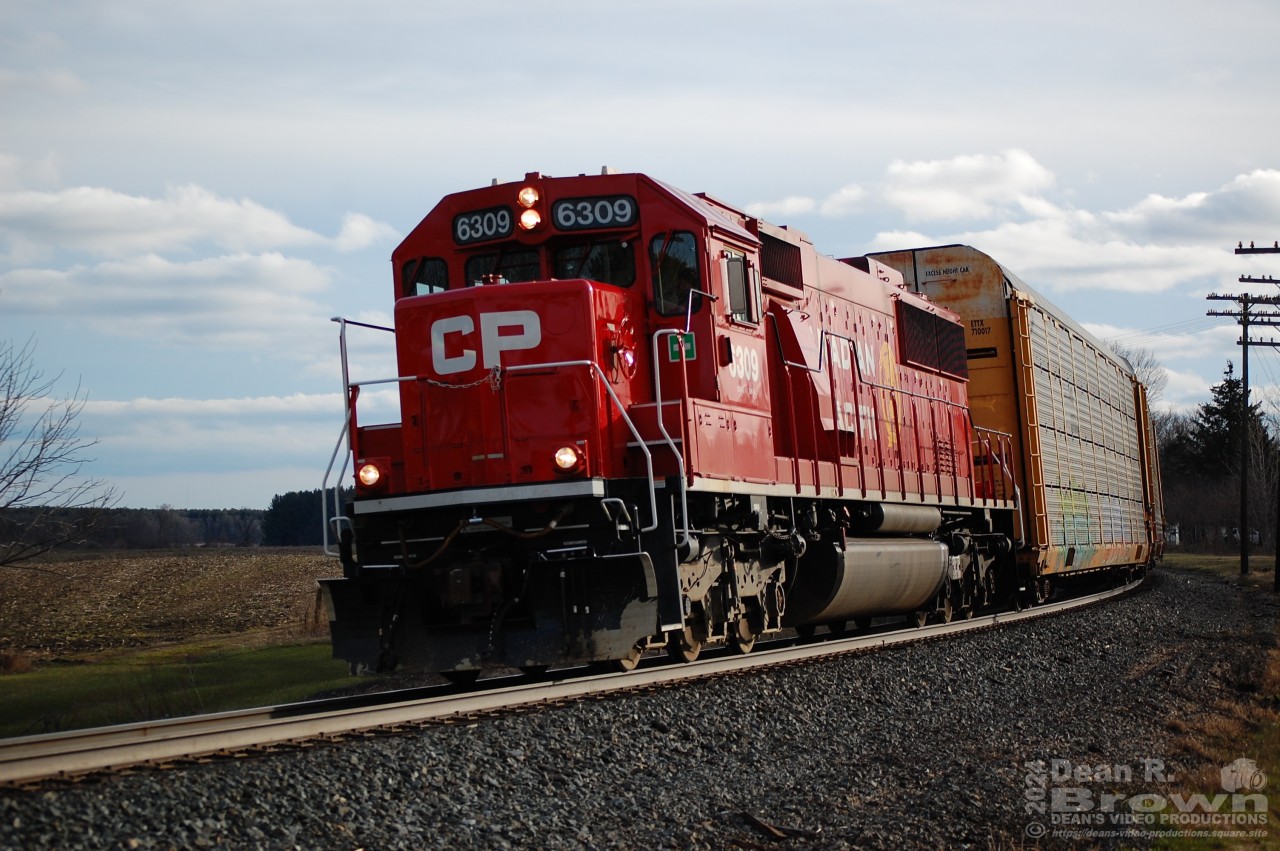 CP Eastbound local with CP SD60-3 6309 and two autoracks head east from Woodstock to Wolverton on March 31/24.