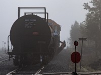 A cool, foggy morning at Kidd, finds the recently arrived crew of Ontario Northland 207 in the midst of working the yard at Kidd. The conductor hangs off a gondola of ore concentrate, guiding his engineer into the joint with a lone tank car left on the main. Once together he will line the north wye switch normal before guiding the movement another four miles further down the line to switch the Ineos Calabrian plant.