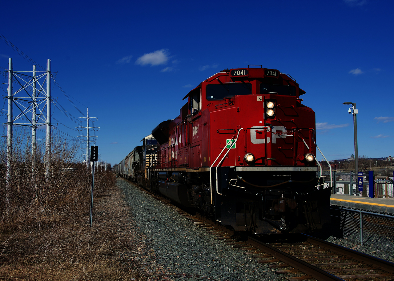 Loaded with grain for Albany, CPKC 328 is passing Du Canal Station with CP 7041 & NS 9828 up front.