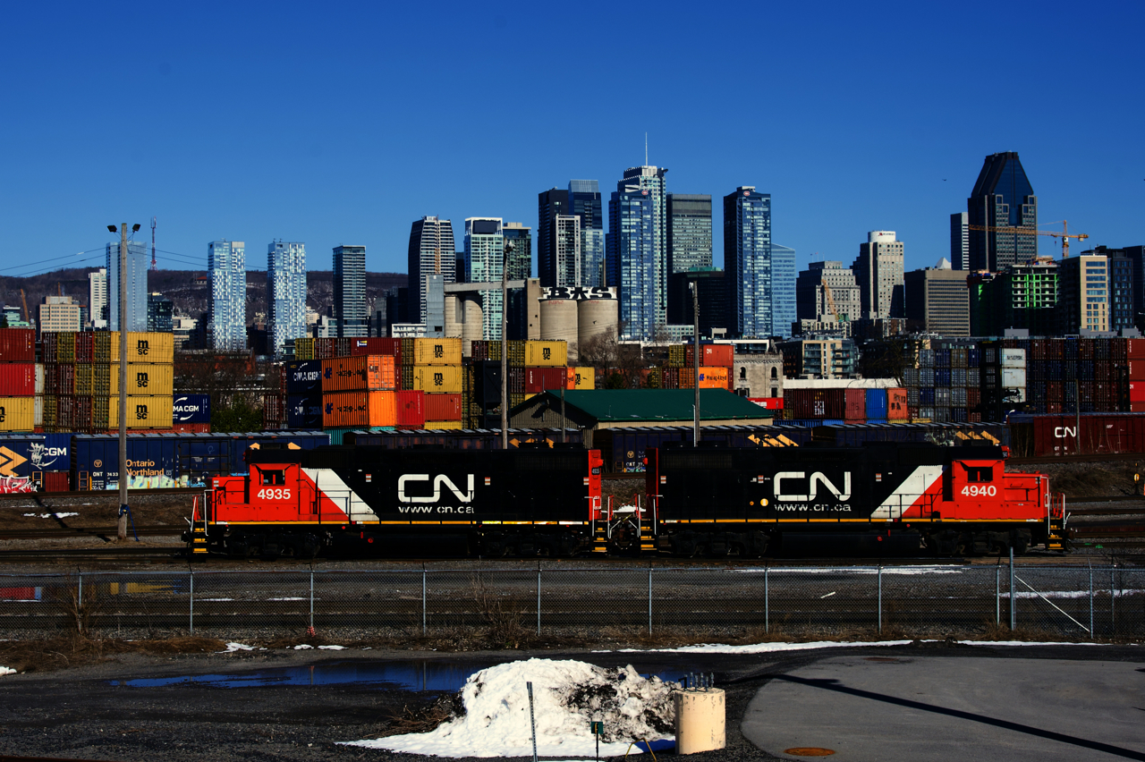 Ex-UP units CN 4935 & CN 4940 are heading west towards Track 29 to pick up loaded grain cars after dropping empty grain cars in the yard.
