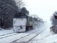 GO Transit F40PH #515 kicks up snow as it races away from its stop at Clarkson, Ontario on January 19, 1985.  The unit was built in May 1978 and eventually sold to Amtrak as their 415.