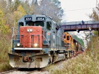 One of those places I miss a lots as far as railfanning goes. Not so much the scenery but just taking in the sights and sounds of a heavy train battling the Niagara Escarpment. The GEXR always put on a good show and had a predictable schedule. Today only passenger traffic runs through here in daylight unfortunately, with all freight traffic under the cover of darkness. This day “Ontario’s Tunnel Motor” leads a heavy 431 upgrade with the old steel road bridge in the background complete with a dad and two young railfans taking in the action. 