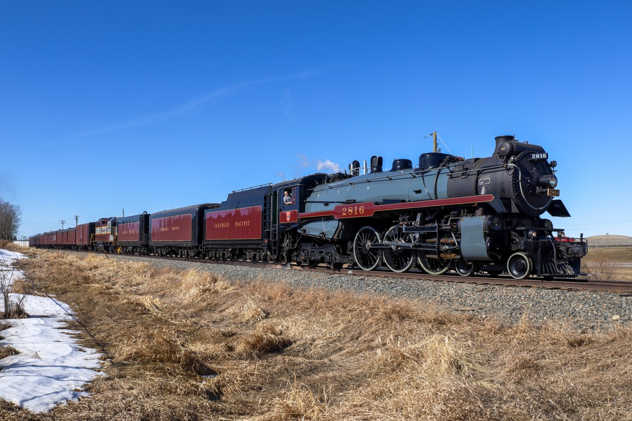 A man and his machine.  The Engineer of the 2816 North looks to be in his element as 40B-18 flies through Innisfail, Alberta.