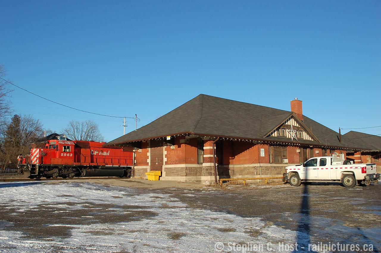On a very late Winter's day in February, we find the London Pickup stopped at the Galt Station getting paperwork. They've just arrived from Guelph Junction and will go north onto the Waterloo Sub to grab their cut of autoracks to bring to London. Built in 1899, with a freight shed built in 1900, both buildings still stand today and are used by MOW crews. The CP (now CPKC) Holiday train will stop here for an event once a year, which is why there's Christmas lights on the outside, at least there was in the early 2000's.