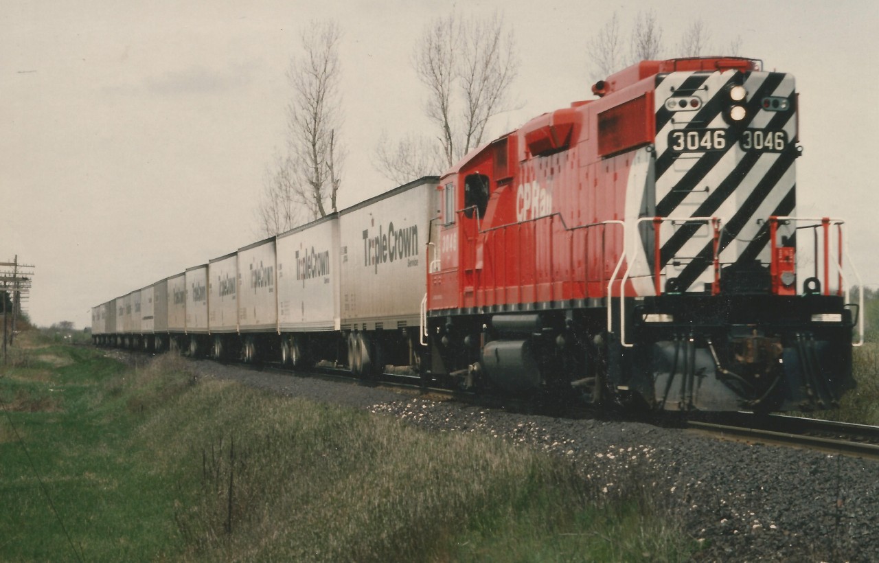 This is a scan of a Gord Taylor photo showing CP's early Roadrailer operation. There was no easy way to turn power in the NS Yard in Detroit and on this day, the power was operated in reverse from Detroit to Lambton Yard in the West Toronto area. Note also the adapter car, versus the later coupler mate. This train is comprised of  the early equipment used on the operation, with the adapter car & each trailer having an attached single railway axle instead of separate railway "bogies" or trucks.