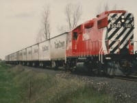 This is a scan of a Gord Taylor photo showing CP's early Roadrailer operation. There was no easy way to turn power in the NS Yard in Detroit and on this day, the power was operated in reverse from Detroit to Lambton Yard in the West Toronto area. Note also the adapter car, versus the later coupler mate. This train is comprised of  the early equipment used on the operation, with the adapter car & each trailer having an attached single railway axle instead of separate railway "bogies" or trucks.  