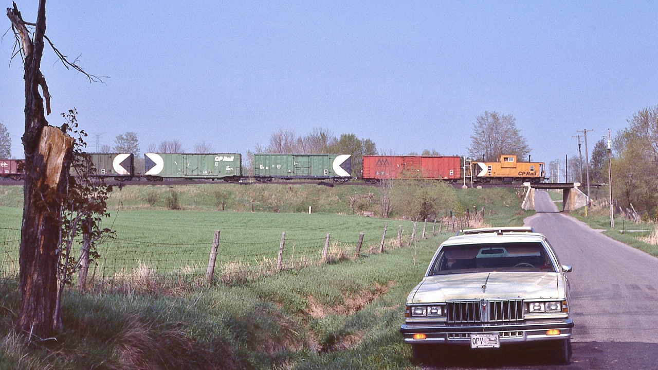 CP Rail 434723, built 1981 by CP Angus, holds the markers,


 At the west end Lovekin, mile 155.6 Belleville Subdivision, 


 CP Rail Second 927, the view from Concession road #1, May 11, 1985 Kodachrome by S Danko


 Head end:


      CP Rail  second 927   


And the 1979 Pontiac Parisienne wagon.


sdfourty