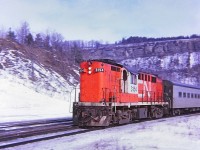 A sunny winter afternoon, CN 3154 with TEMPO paint scheme and coaches flying along westward at Dundas. A "Kodak Instamatic Memory" from long ago.