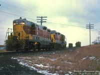 Algoma Central Railway GP7's 154 and 150, leased by CP Rail for a time in 1978-1979, work the interchange track in Port Hope after making their way east with CP's Cobourg Turn on the Belleville Sub from <a href=http://www.railpictures.ca/?attachment_id=44051><b>Toronto Yard</b></a>. The two units are seen at the interchange switch around the old Smith Street grade crossing (now closed). The interchange track led downgrade to a small CN yard off the CN's Kingston Sub, near the present day VIA Rail station.
<br><br>
<i>Keith Hansen photo, Dan Dell'Unto collection slide.</i>