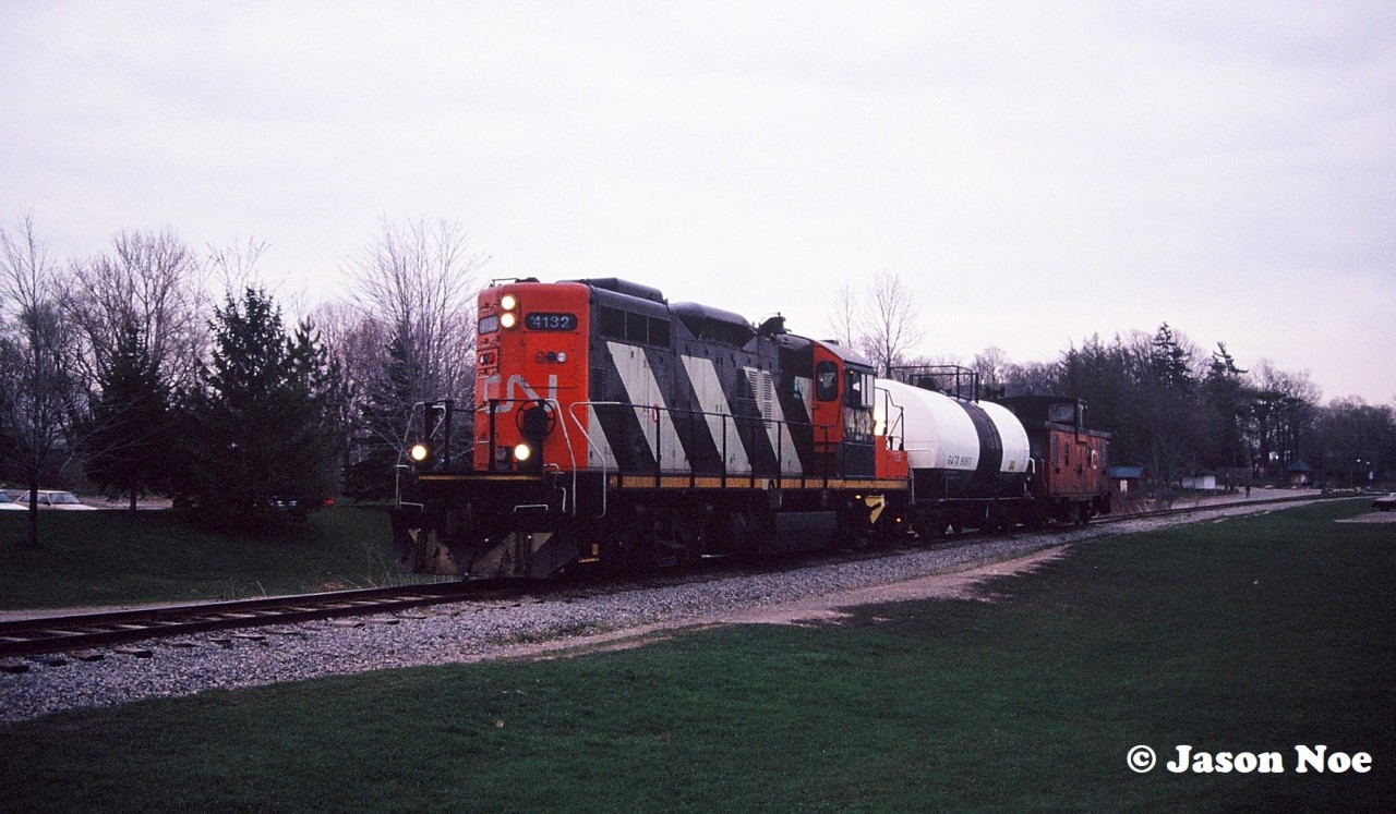 CN GP9RM 4132 leads the 15:30 Kitchener Job through Waterloo Park approaching Seagram Drive in Waterloo, Ontario. The job has one tank car for Sulco in Elmira on the Waterloo Spur.